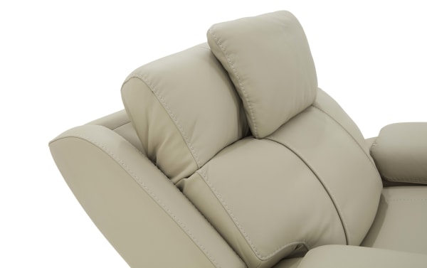 Beige leather recliner chair headrest with cushioned, segmented padding and detailed stitching for ergonomic neck and back support.