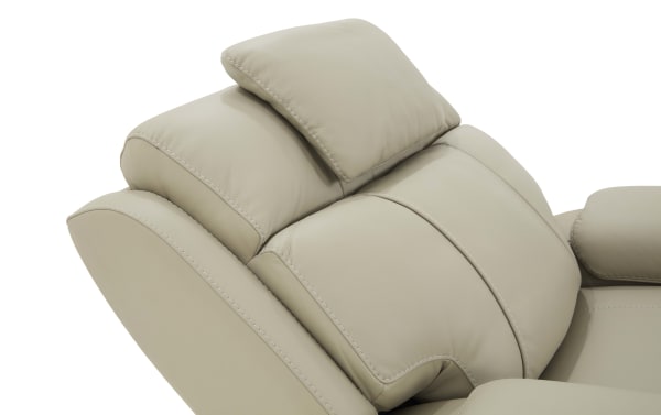 Beige leather recliner chair backrest with cushioned headrest and ergonomic stitching for enhanced comfort and support.