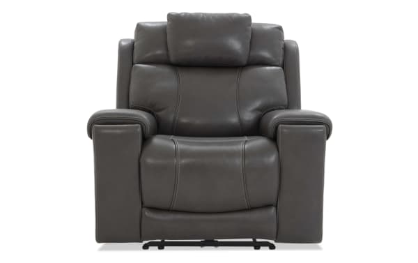 Dark gray leather recliner chair with cushioned armrests, padded backrest, and visible stitching, designed for comfort and style.