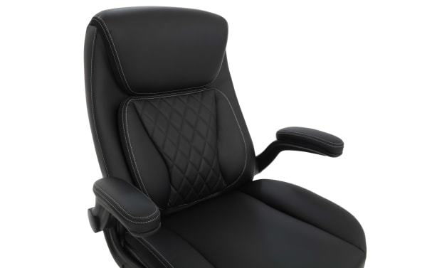 Black ergonomic office chair with padded armrests, quilted backrest cushion, and white contrast stitching on synthetic leather upholstery.