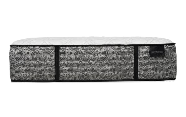 Mattress side view with a gray and white paisley pattern fabric, black trim, quilted white top, and a black label reading "DISTINCTION."