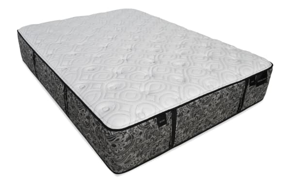Mattress with a white quilted top featuring circular and diamond patterns, gray floral-patterned sides, and labels reading "PLUSH" and "DISTINCTION."