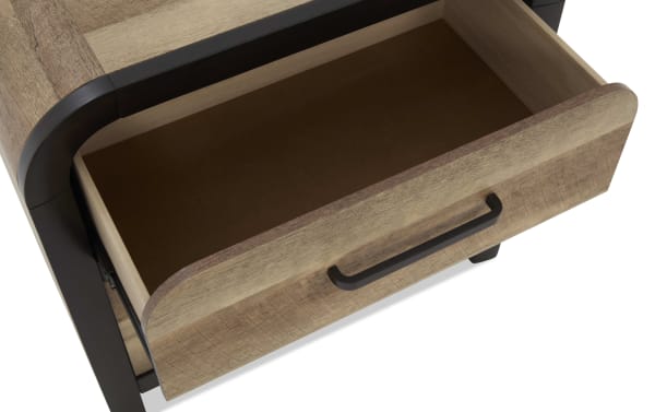 Open wooden drawer with a black metal handle, featuring a smooth light brown finish and rounded edges, part of a modern wooden furniture piece.