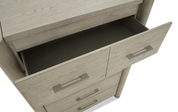 Light wood dresser drawer with matte silver handles, shown partially open to display interior storage space, highlighting modern bedroom furniture design.