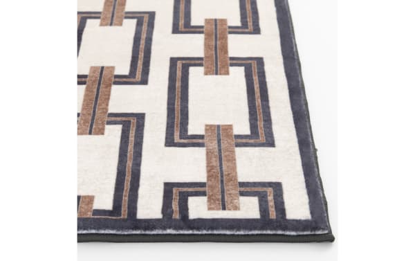 Area rug with a geometric pattern featuring interlocking rectangles in brown and dark gray on a cream background, with a dark gray border.
