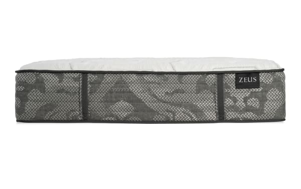 Zeus mattress side view showing gray patterned fabric with black trim and white quilted top, highlighting mattress thickness and design.