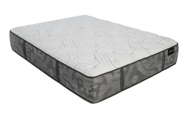 Zeus brand mattress with a quilted white top and patterned gray fabric sides, featuring side handles for easy lifting.