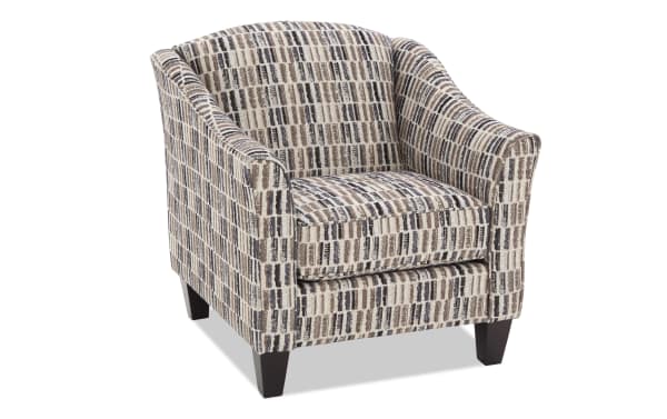 Upholstered armchair with a modern geometric pattern in beige, brown, and black tones, featuring dark wooden legs and a cushioned seat.