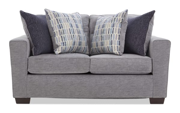 Gray fabric loveseat with two patterned blue and beige cushions and two solid dark blue cushions, featuring a modern design and wooden legs.