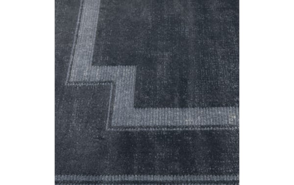 Dark gray textured carpet with a subtle geometric border pattern in lighter gray, showcasing a modern and minimalist design.