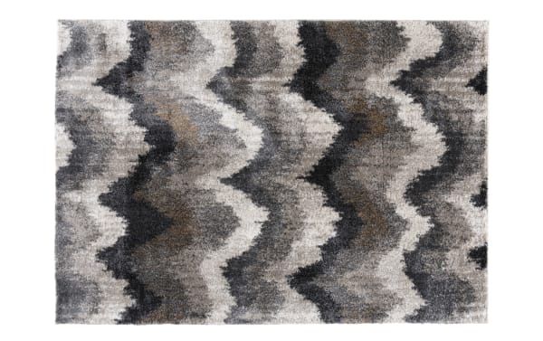 Shaggy area rug with a wavy zigzag pattern in shades of gray, black, and beige, featuring a soft, plush texture ideal for modern home decor.