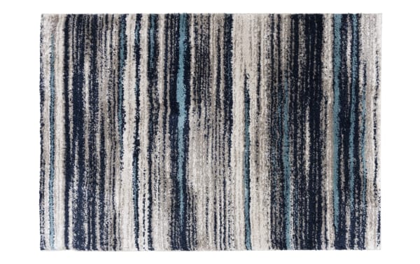 Rectangular area rug with a striped pattern in shades of blue, gray, black, and white, featuring a textured, plush material suitable for modern home decor.