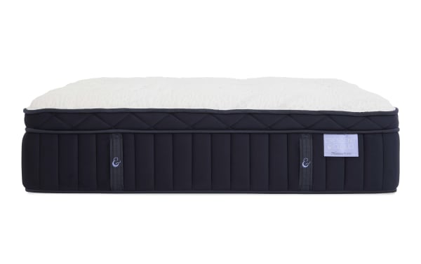 Crescent & Cloud mattress with plush white quilted top and dark navy blue sides featuring vertical stitching and fabric handles.