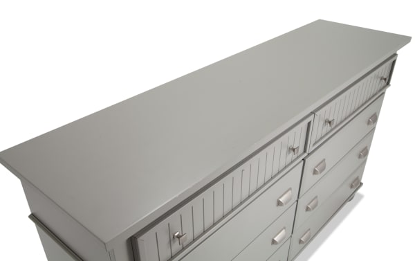 Spencer Gray 8 Drawer Dresser in transitional style featuring hardwood solids, MDF, plywood, and poplar construction with vertical groove drawer fronts and metal handles.