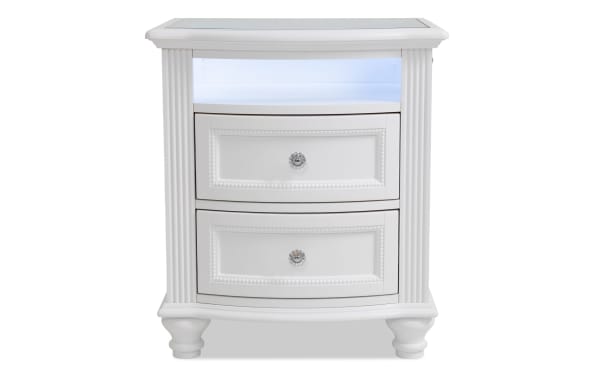 Madelyn White 2 Drawer Nightstand with poplar and pine solids, featuring faux crystal ball hardware, curved front, fluted columns, and top shelf LED nightlight.