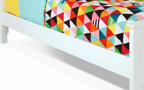 White Spencer Twin Panel Bed with transitional style, featuring hardwood solids, MDF, plywood, and poplar construction, showcasing a sleek, simple design with a colorful geometric quilt.