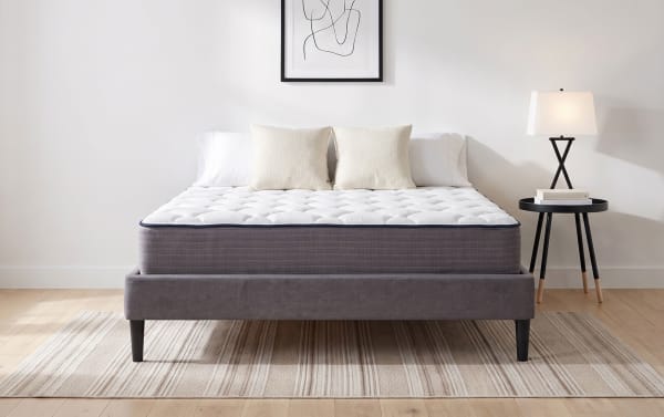 Mismatched Bedding 10.5" Queen Firm Mattress with white quilted top, gray sides, and tufted innerspring design on a gray platform bed frame.