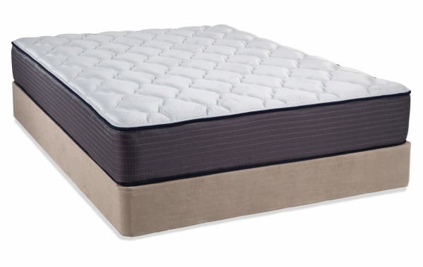 Queen size Mismatched Bedding mattress set with white quilted polyester fabric mattress top and dark gray mattress sides on a beige fabric foundation.