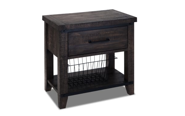 Rustic Montana Brown Nightstand with Drawer from Montana Bedroom collection, made of MDF, pine solids, and pine veneer, featuring a dark wood finish, black metal handle, soft-closing drawer, and a lower shelf with a removable black wire basket for versatile storage.