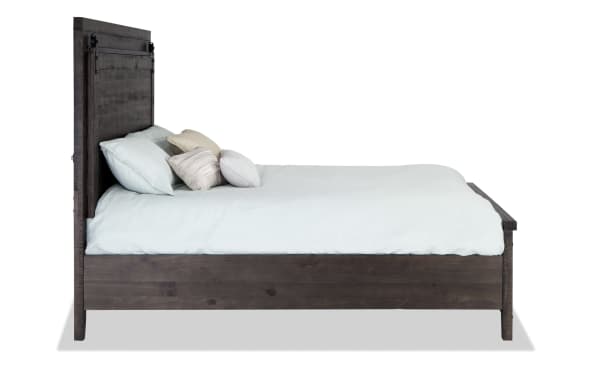 Rustic Montana 4 Piece Queen Brown Storage Platform Bed made of pine solids, MDF, and pine veneer with a tall headboard and soft blue bedding.