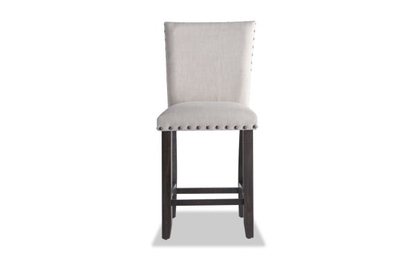 Sonoma Espresso & Beige Solid Back Upholstered Counter Height Stool with beige polyester fabric, nailhead trim, and solid acacia wood legs.