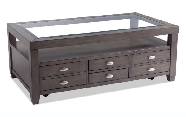 Prestige Gray Storage Coffee Table with tempered glass top, beveled edge, solid acacia wood, platinum finish, dual-access drawers, metal handles, and casters for easy mobility.