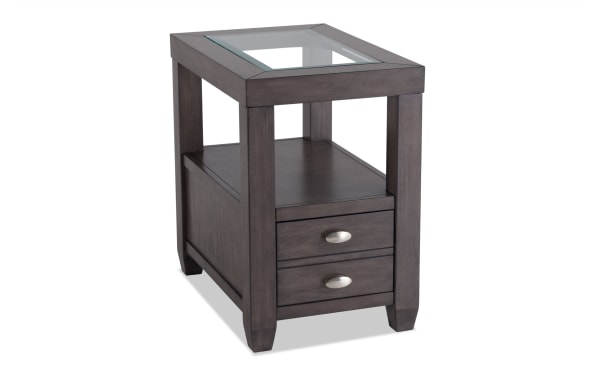 Prestige Gray Storage Chairside Table from Prestige Occasional collection, transitional style with solid acacia, MDF, glass top, beveled edge, two drawers with oval metal handles, open shelf, and built-in USB ports and power outlets for device charging.