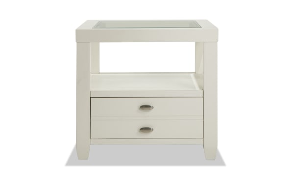 Prestige White Storage End Table from Prestige Occasional collection, transitional style with solid acacia, MDF, white finish, beveled glass top, oval metal handles, one drawer, and open shelf for stylish living room storage.