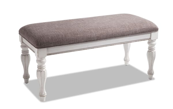 Scarlett White Storage Bench in taupe fabric with distressed white farmhouse-style wood legs, featuring birch veneer and polyester upholstery.