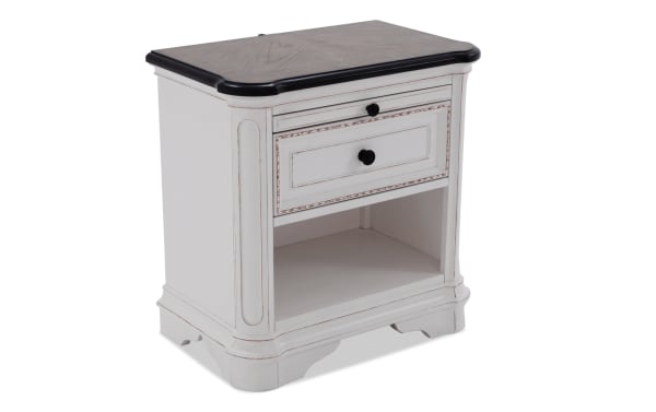 Scarlett White & Oak Nightstand with Drawer in farmhouse style, featuring distressed white MDF/acacia veneer, black wood top, antique brass hardware, felt-lined drawer, open shelf, and elegant curved edges.