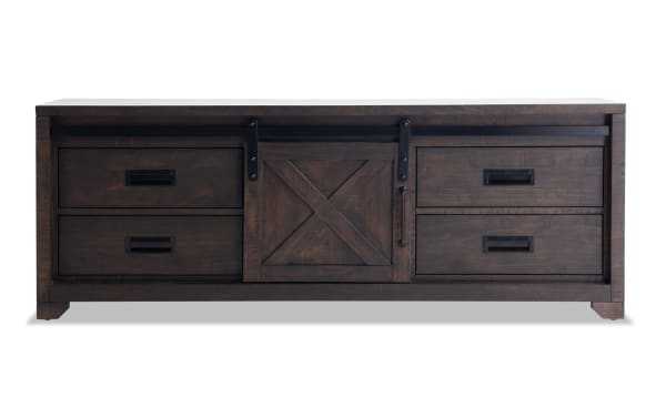 Montana 65'' brown rustic TV stand with pine solids, MDF, pine veneer; features sliding barn door, four drawers, ample media storage.