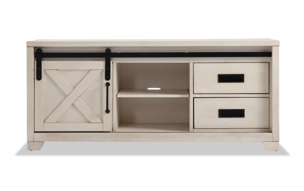 Montana 55'' White Rustic TV Stand with pine solids, MDF, and pine veneer. Features sliding barn door, open shelves, and two drawers for media storage.