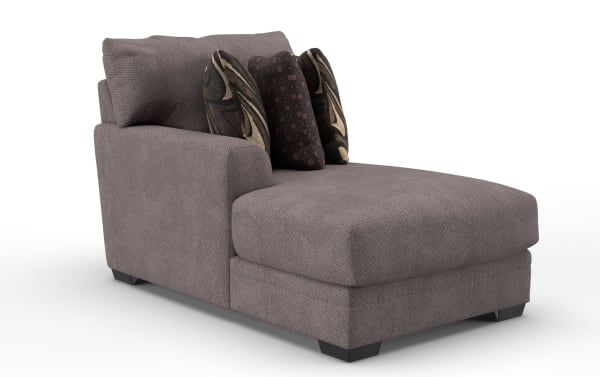 Gray upholstered chaise lounge with textured fabric, featuring three decorative patterned throw pillows and a cushioned backrest, ideal for modern living rooms.