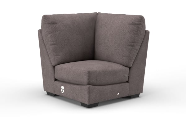 Gray fabric corner chair with plush cushions, modern design, and low black feet, ideal for living room seating and space-saving arrangements.