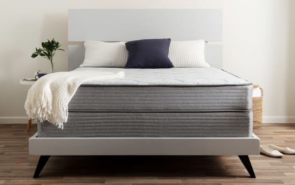 Bob's Val-U-Pedic 8'' Twin Plush Standard Mattress Set with gray innerspring, white knit cover, memory foam layer, on modern light gray bed frame.