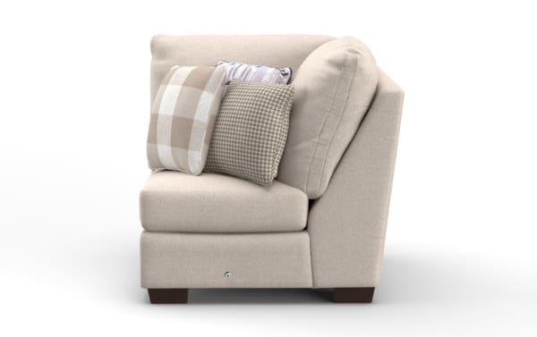 Beige fabric corner sofa section with angled backrest, dark wooden legs, and three decorative cushions in plaid, houndstooth, and abstract patterns.