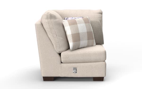 Beige fabric corner sofa section with dark wooden legs, plush cushions, and three decorative pillows in neutral patterns, ideal for living room seating.