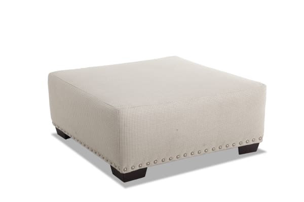 Cottage Chic Beige Ottoman with traditional style, beige gingham polyester fabric, nailhead trim, and dark wooden legs for living room decor.
