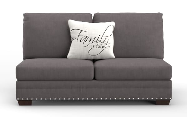 Gray fabric loveseat sofa with dark wooden legs and silver nailhead trim, featuring a white decorative pillow with the text "Family is forever" in elegant script.