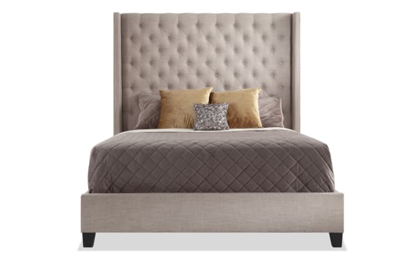 Emerson King Beige Upholstered Panel Bed with tall button-tufted taupe polyester fabric headboard, winged accents, and low-profile footboard in transitional style