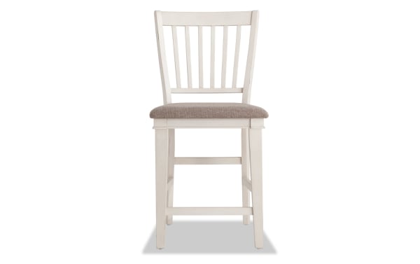 Montana White & Beige Slat Back Counter Height Stool with rustic white rubberwood frame, beige polyester fabric seat, and traditional slat back design.