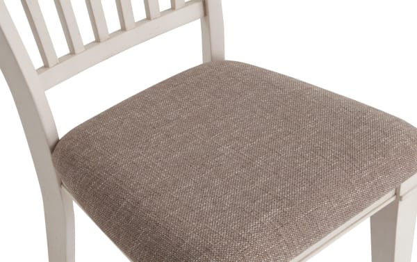 Beige fabric-upholstered seat with rustic white rubberwood slat back frame, part of Montana Dining collection counter height stool.