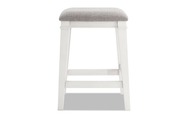 Backless Montana White & Beige Upholstered Counter Height Stool with rustic rubberwood frame, beige polyester fabric seat, and memory foam cushion