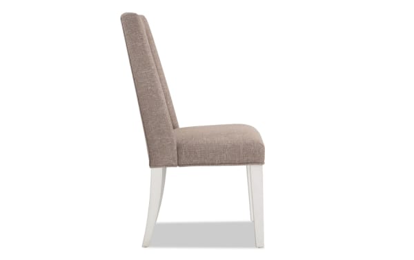 Montana White & Beige Solid Back Upholstered Dining Chair with beige polyester fabric, rustic style, memory foam seat, and white rubberwood legs.