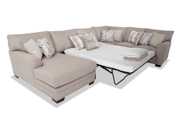 Cottage Chic Beige 4-piece left arm facing sleeper chaise sectional with queen gel mattress, traditional style, beige polyester fabric, nailhead trim, and 10 accent pillows.