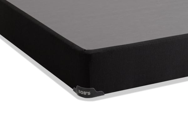 Black fabric-covered Distinction Standard Twin XL Foundation by Bob’s, featuring durable corner guards for mattress support and protection.
