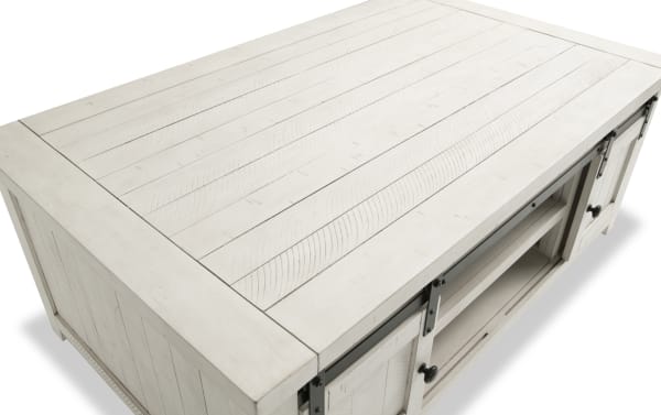 Rustic Montana White Storage Coffee Table from Montana Entertainment & Occasional, made of pine solids and plywood with gliding barn doors and casters for mobility.