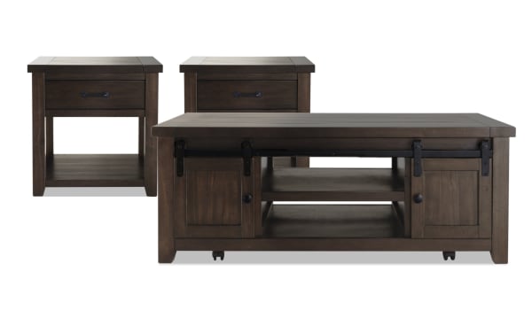 Montana Brown Storage Coffee Table and 2 End Tables set in rustic pine solids and plywood. Features barn door cabinet, casters, drawer, and bottom shelf.
