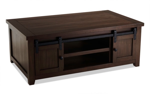 Rustic Montana Brown Storage Coffee Table from Montana Entertainment & Occasional collection, made of pine solids and plywood, with dark brown finish, gliding barn doors, and ample storage space.