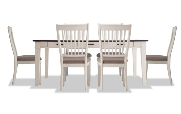 Montana 7 Piece Rustic Dining Set with white rubberwood frame, beige polyester upholstered chairs, oak veneer distressed tabletop, and six storage drawers.